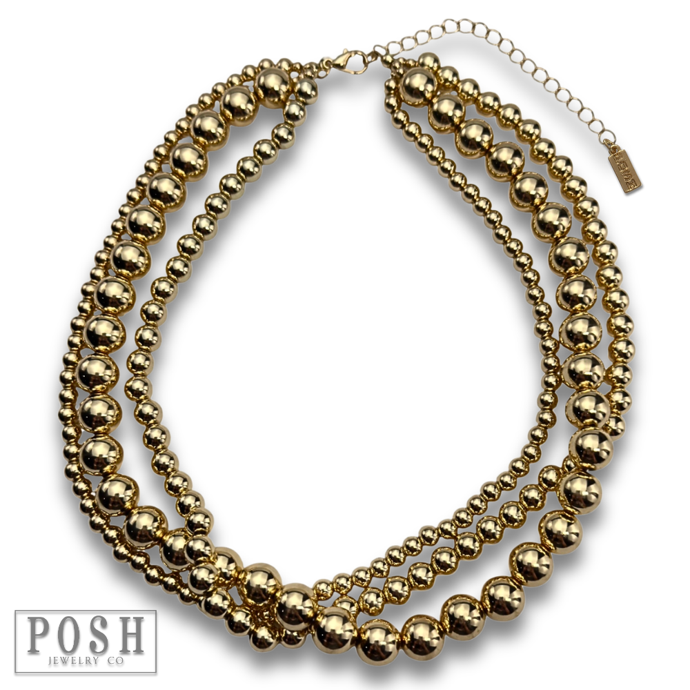 Three strand gold beaded necklace