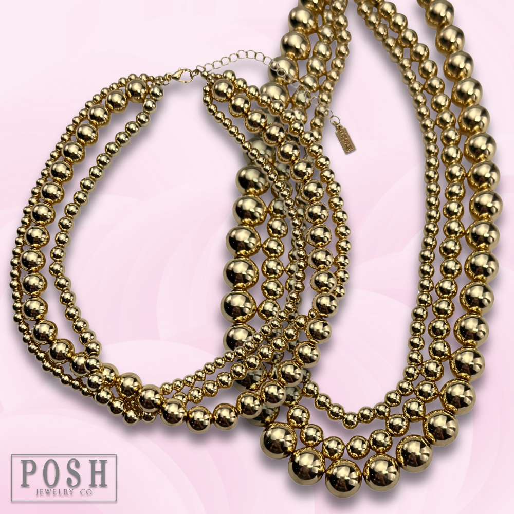 Three strand gold beaded necklace
