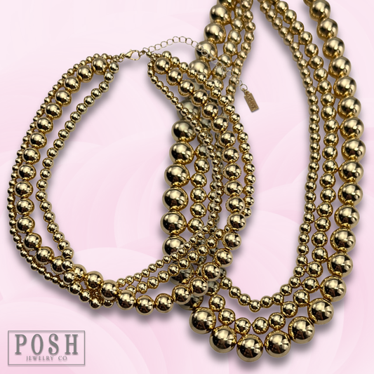 Three strand gold beaded necklace