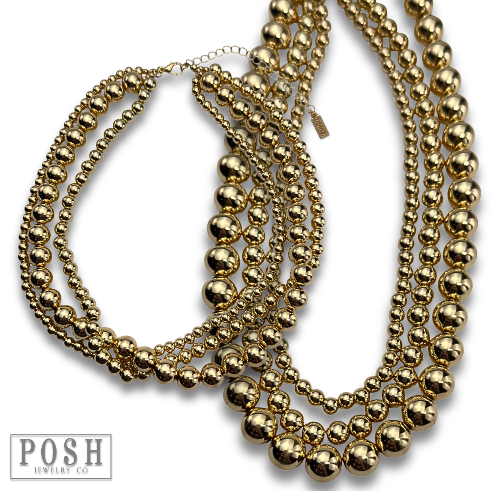 Three strand gold beaded necklace